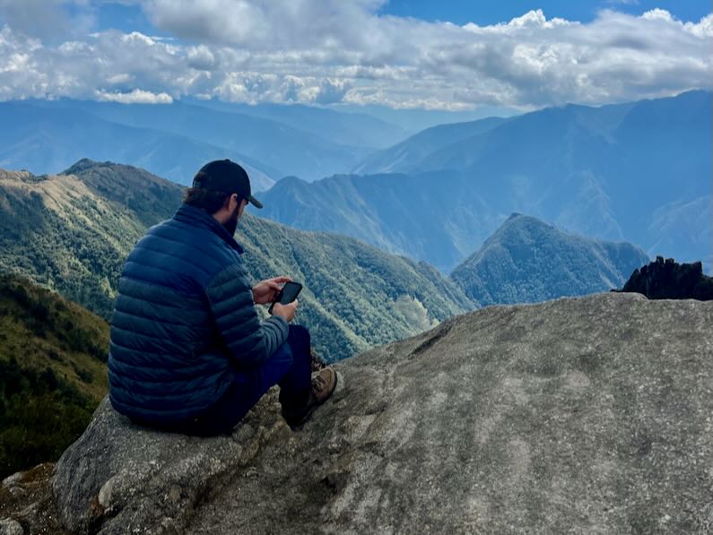 Checking text and emails at Phuyupatamarka campsite